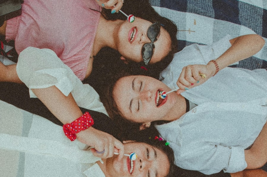 Girls licking lollipops for saliva production